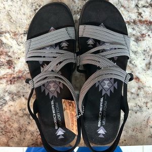 Gray and black cushion sketcher sandals.